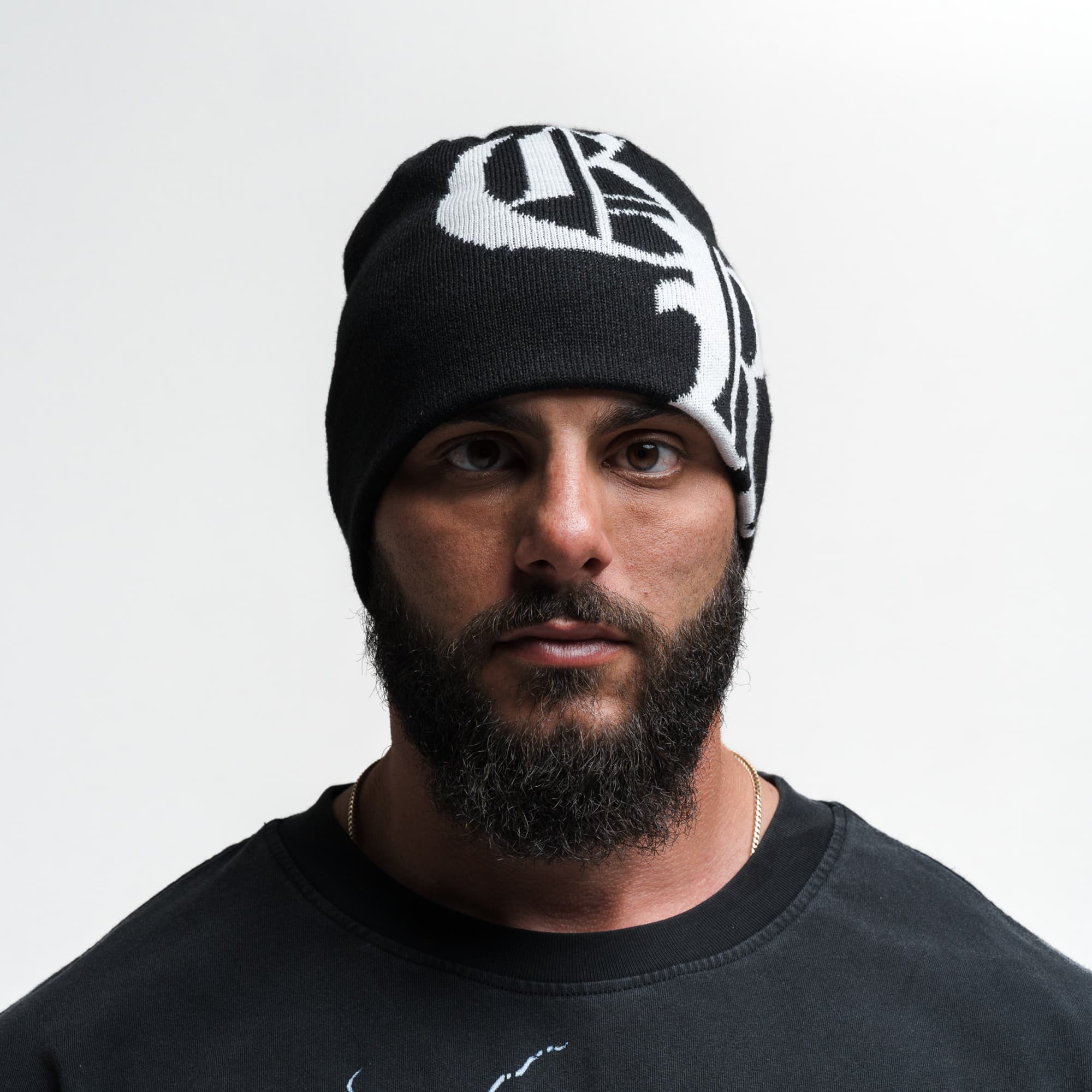 Athlete wearing Initial Skull Cap Beanie - Black/White front view