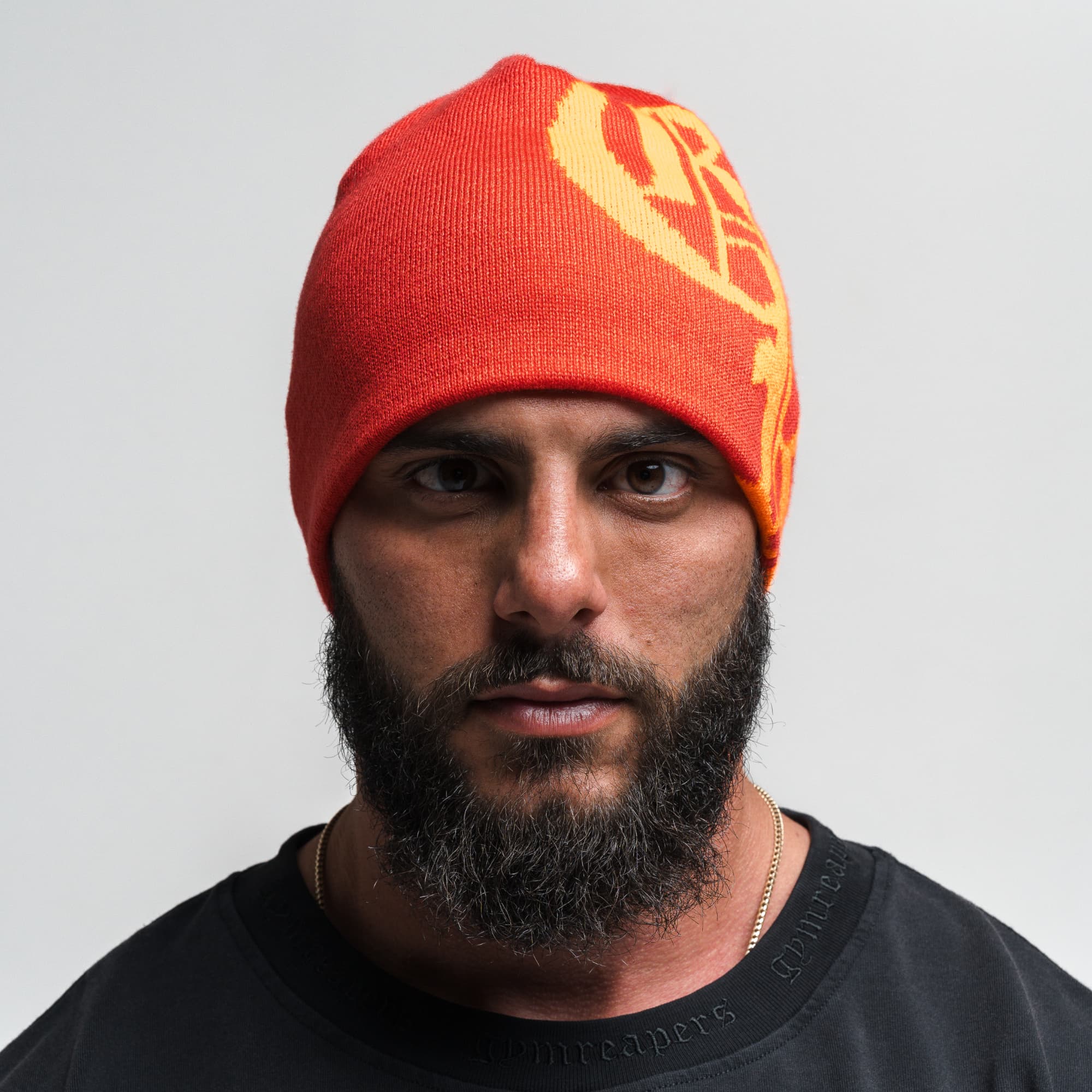 Athlete wearing Initial Skull Cap Beanie - Red/Orange front view