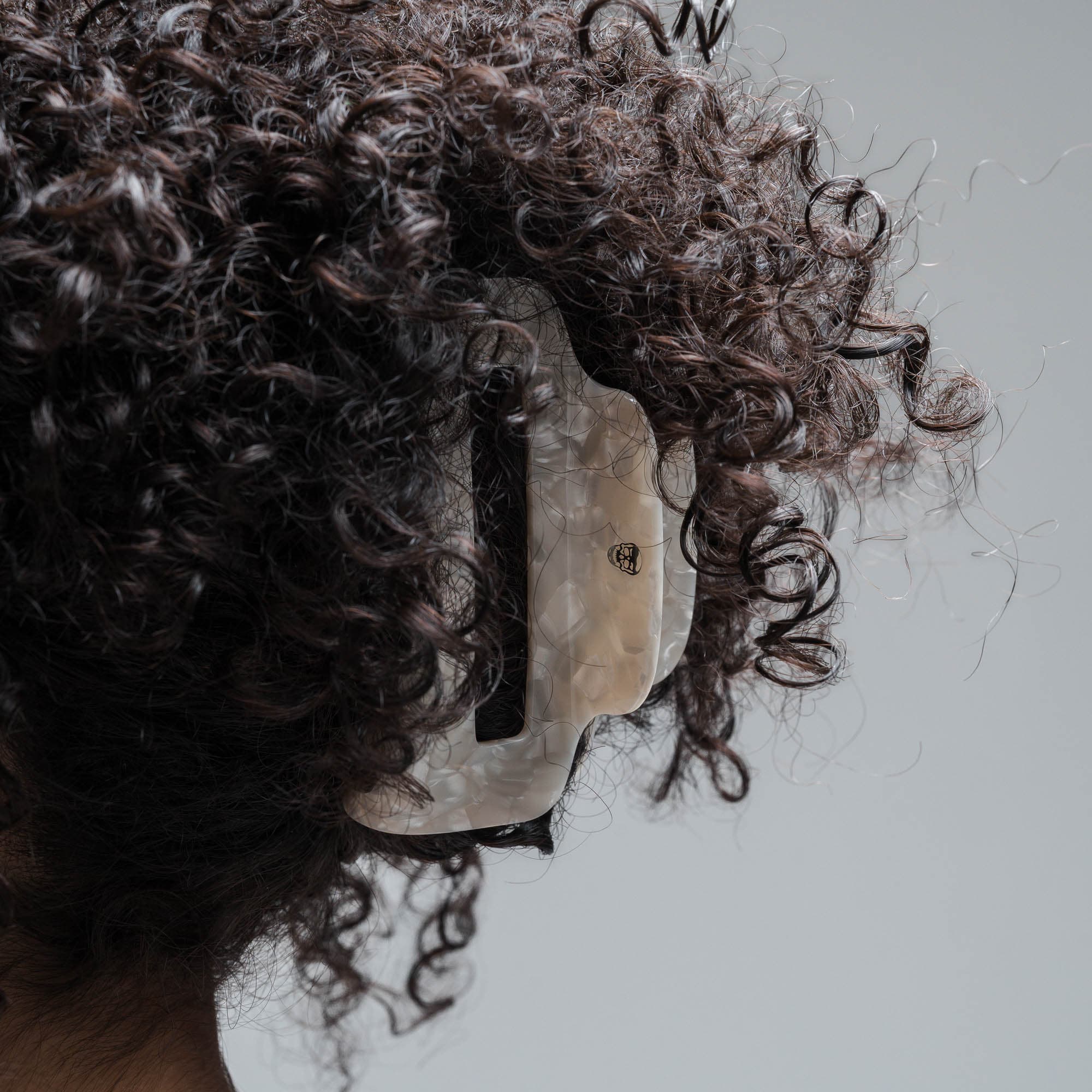 model wearing Large Claw Clip - Ivory curly brown hair