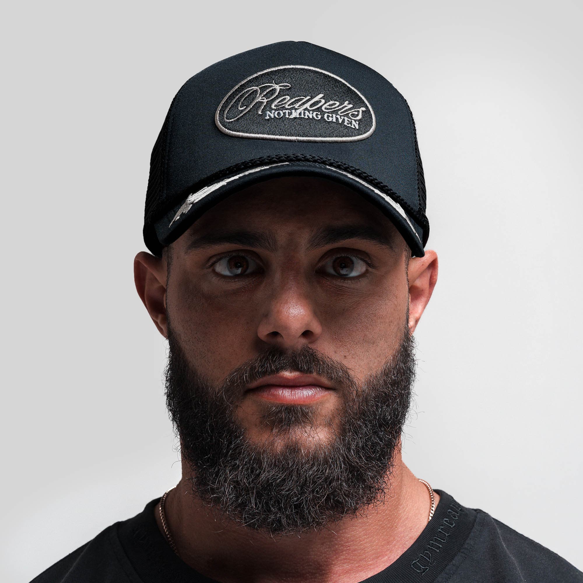 Athlete wearing Laurel Foam Trucker Hat - Black front view