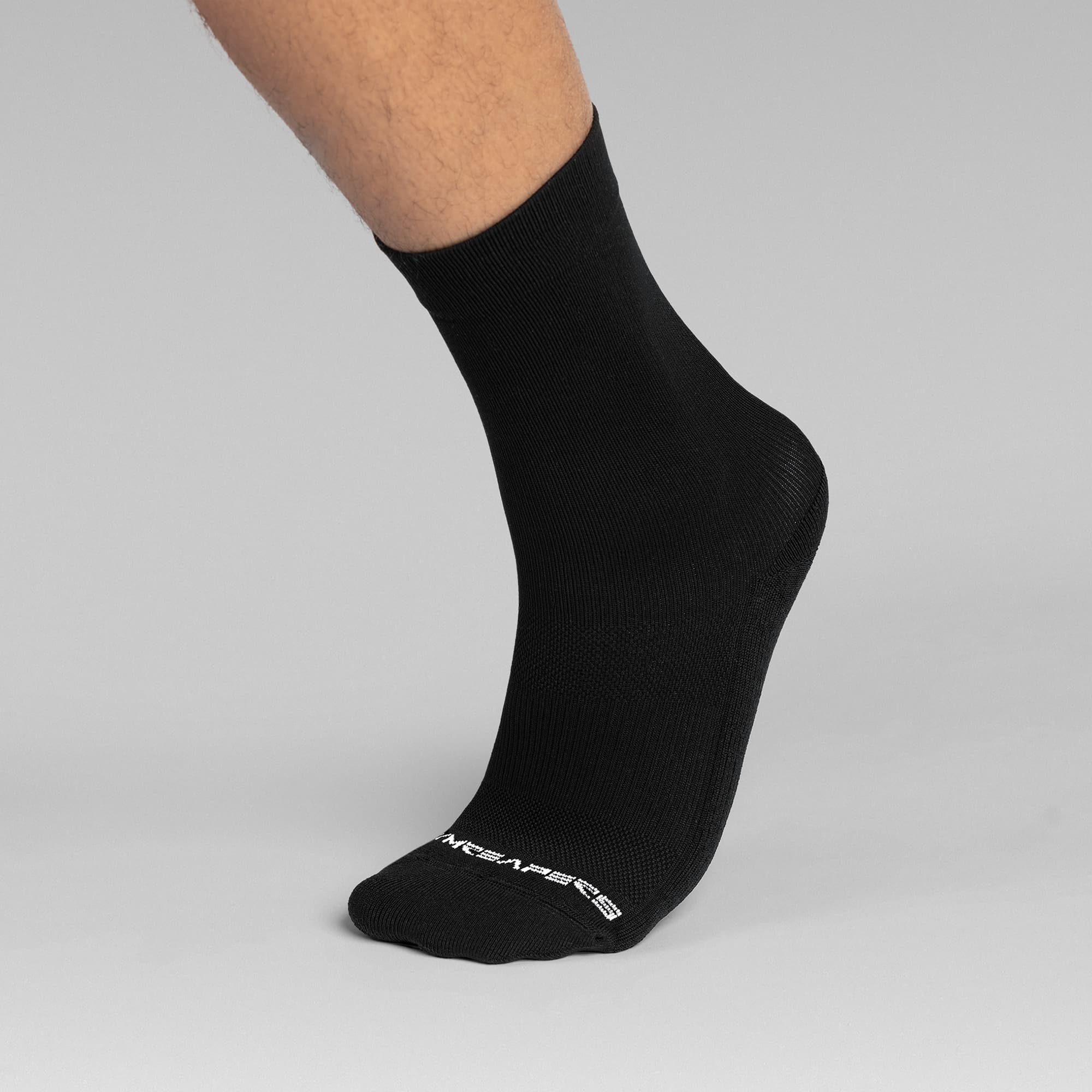 Athlete wearing the Black Stryda™ Crew Run Socks side view taking step