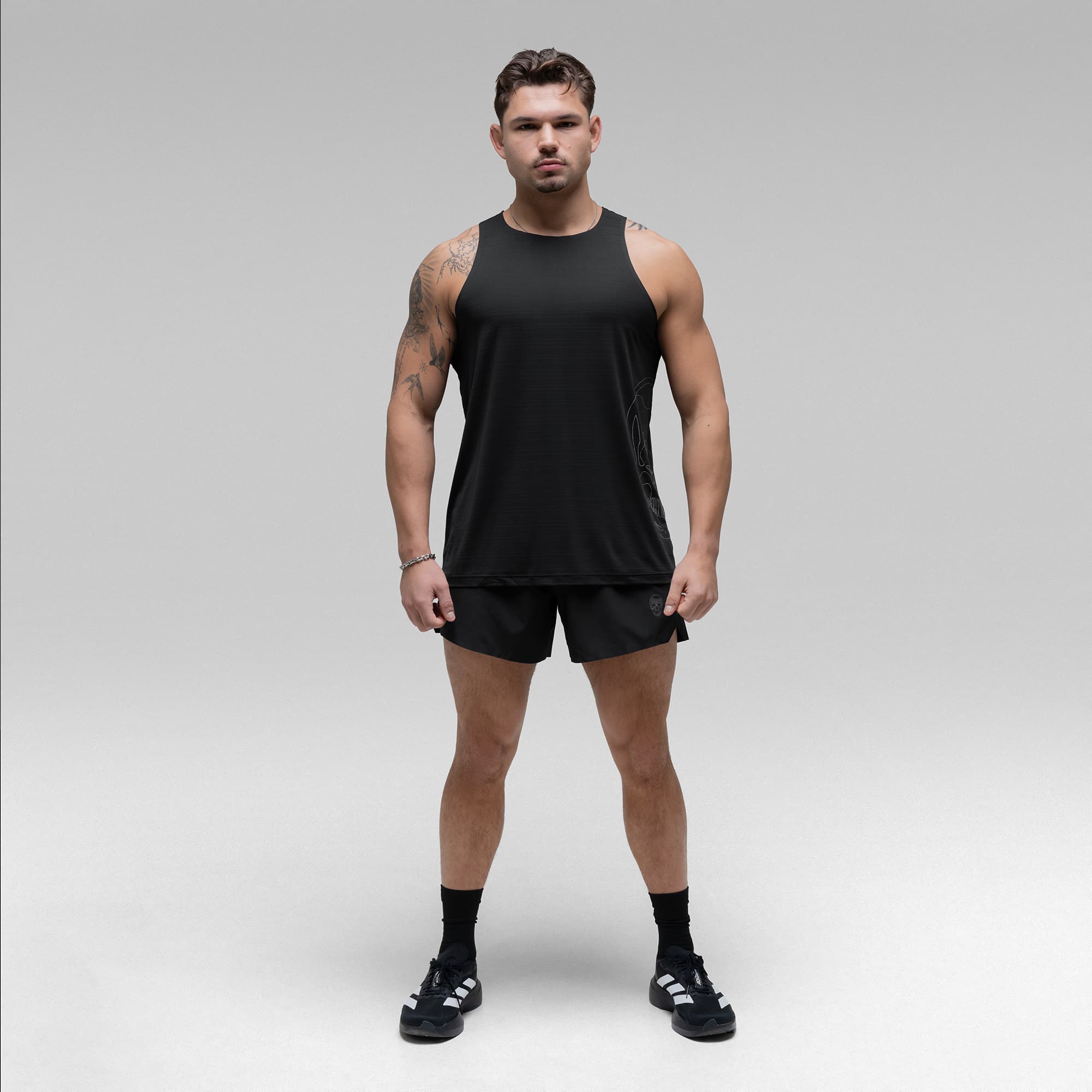 Athlete wearing the Ghost Racer Tank full body shot front view