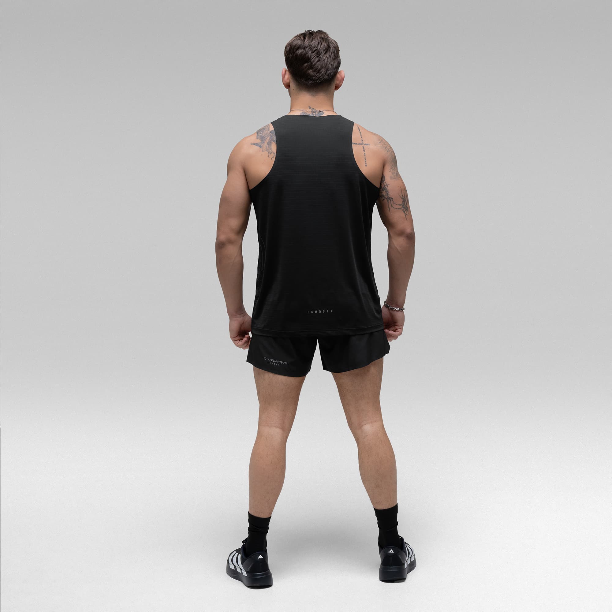 Athlete wearing the Ghost Racer Tank full body shot back view