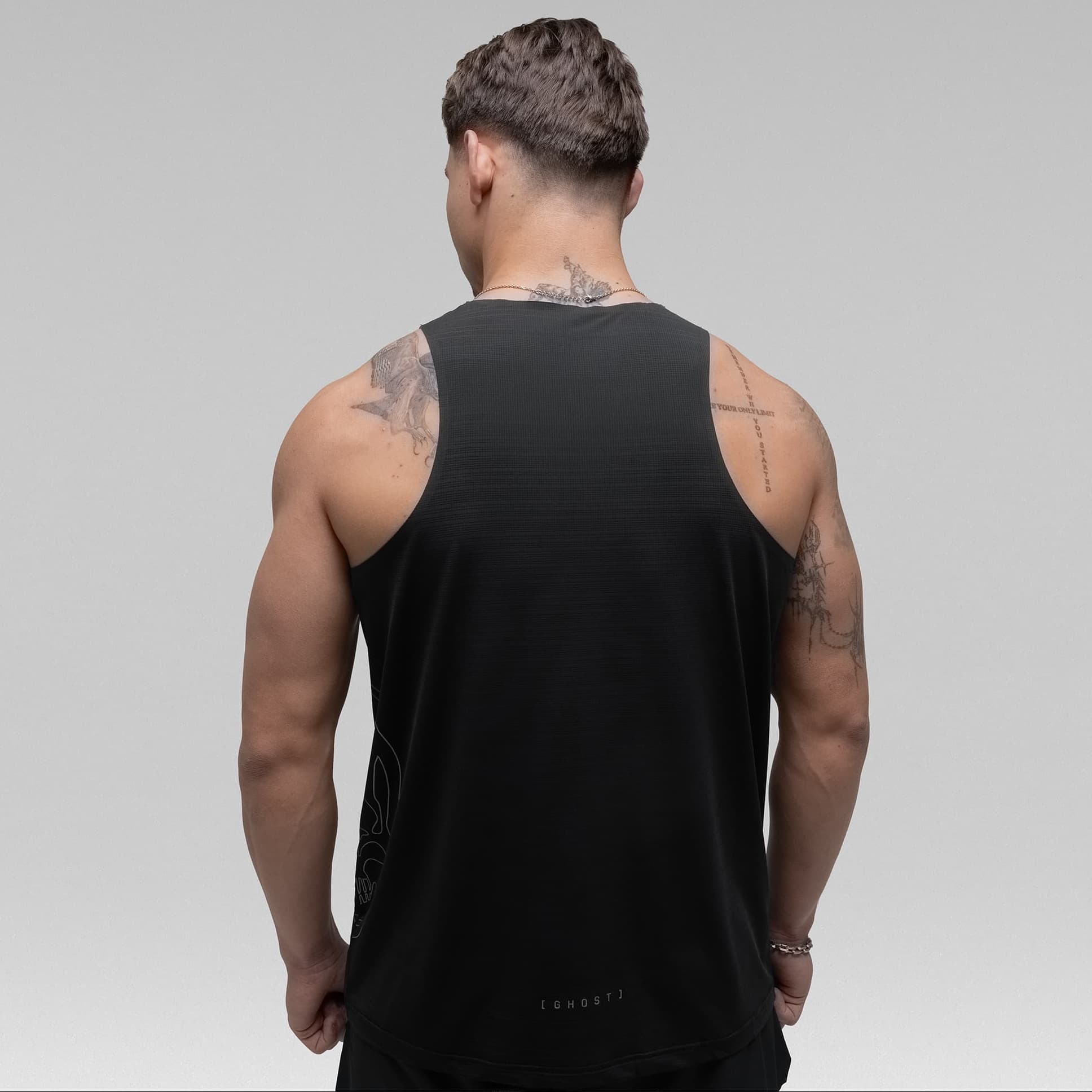 Athlete wearing the Ghost Racer Tank half body shot back view
