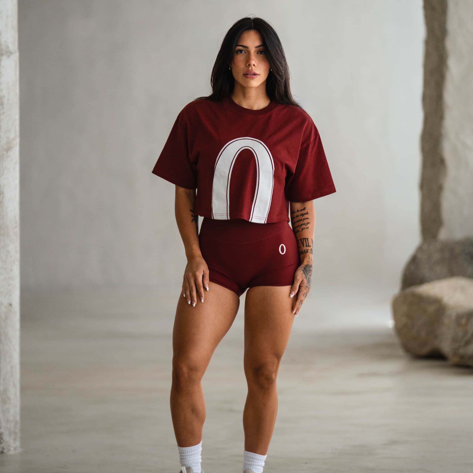 Full-body view of model in Olympia 4" Training Shorts and Olympia cropped tee.