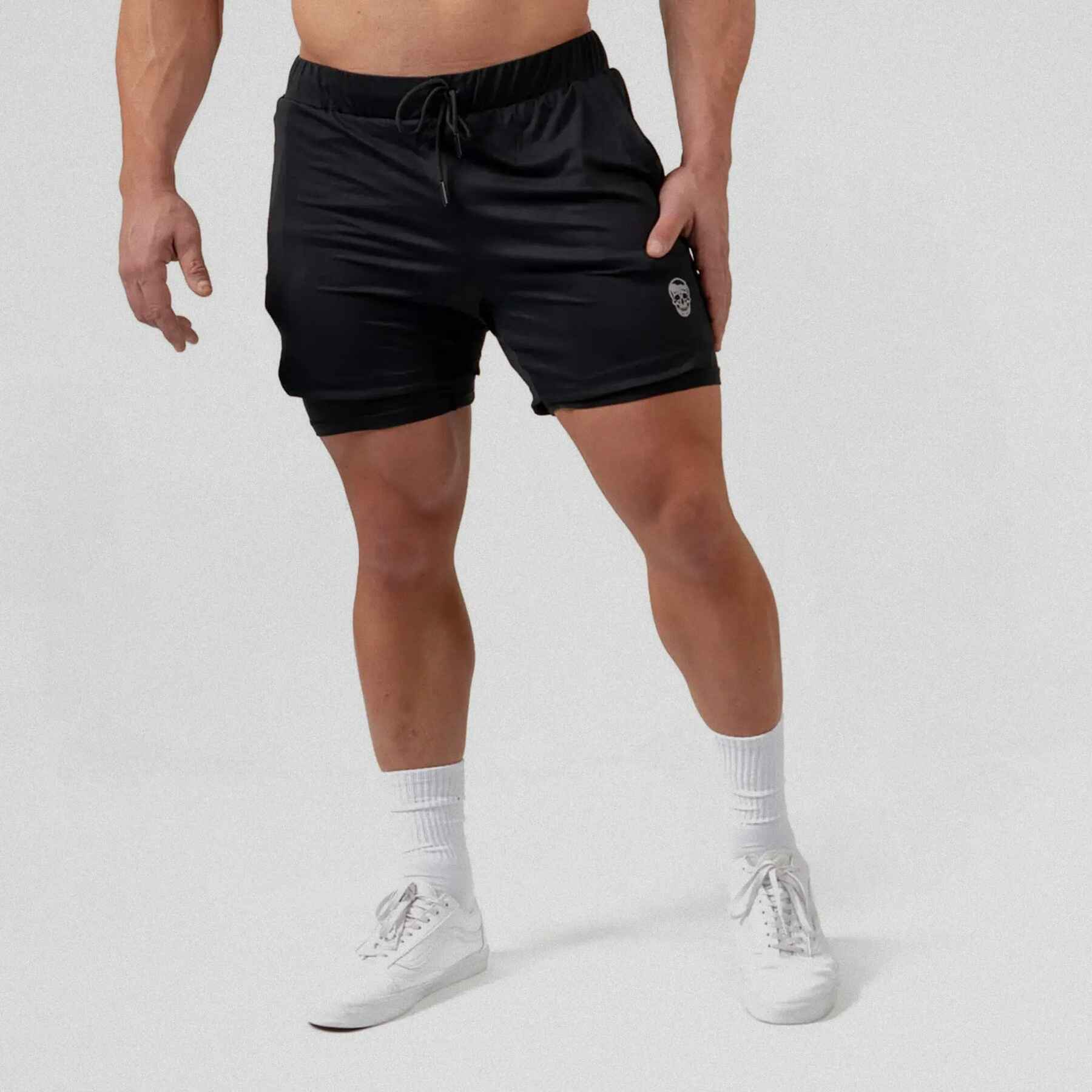 React training shorts black color way on athlete holding the side