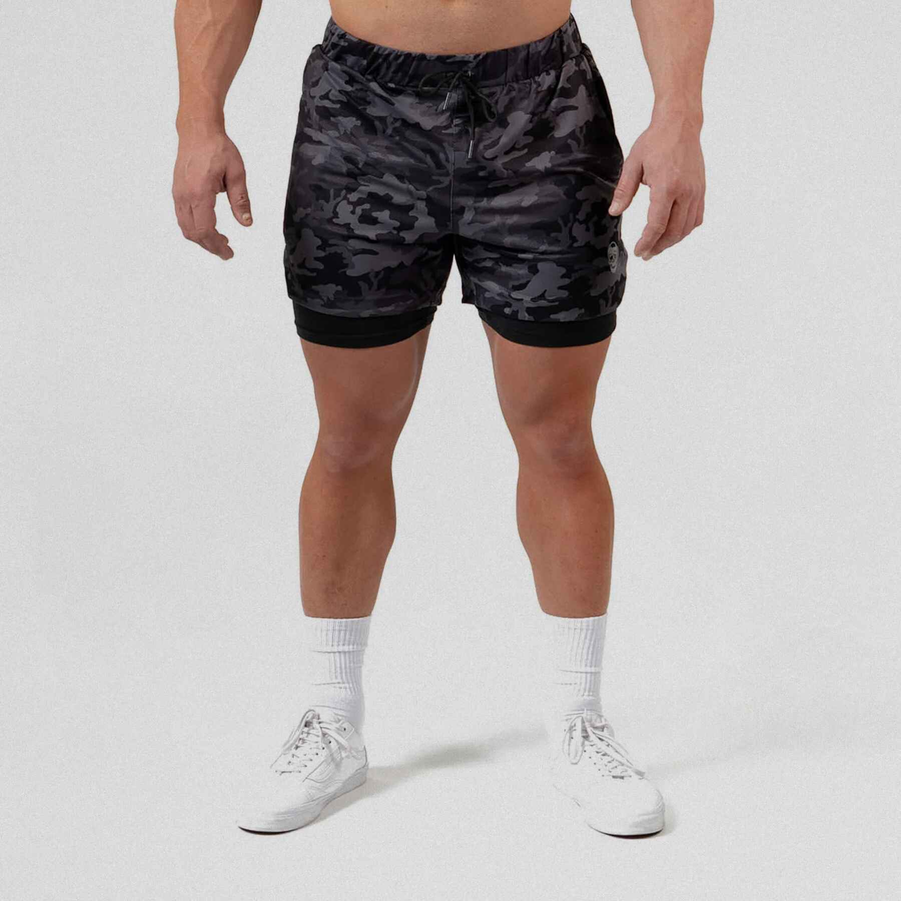 Gymreapers react training shorts midnight camo with athlete wearing them,  showcasing the front slightly zoomed out.