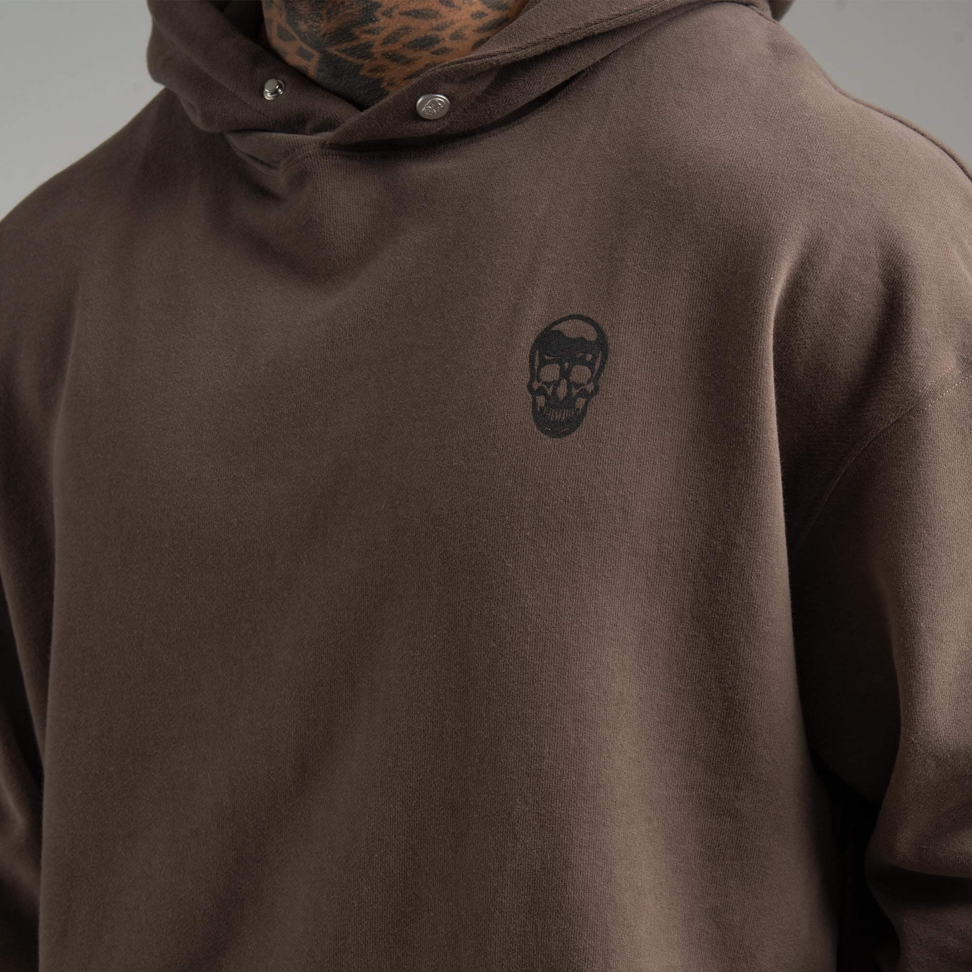 athlete wearing Toffee Heavyweight Hoodie close up of skull detail