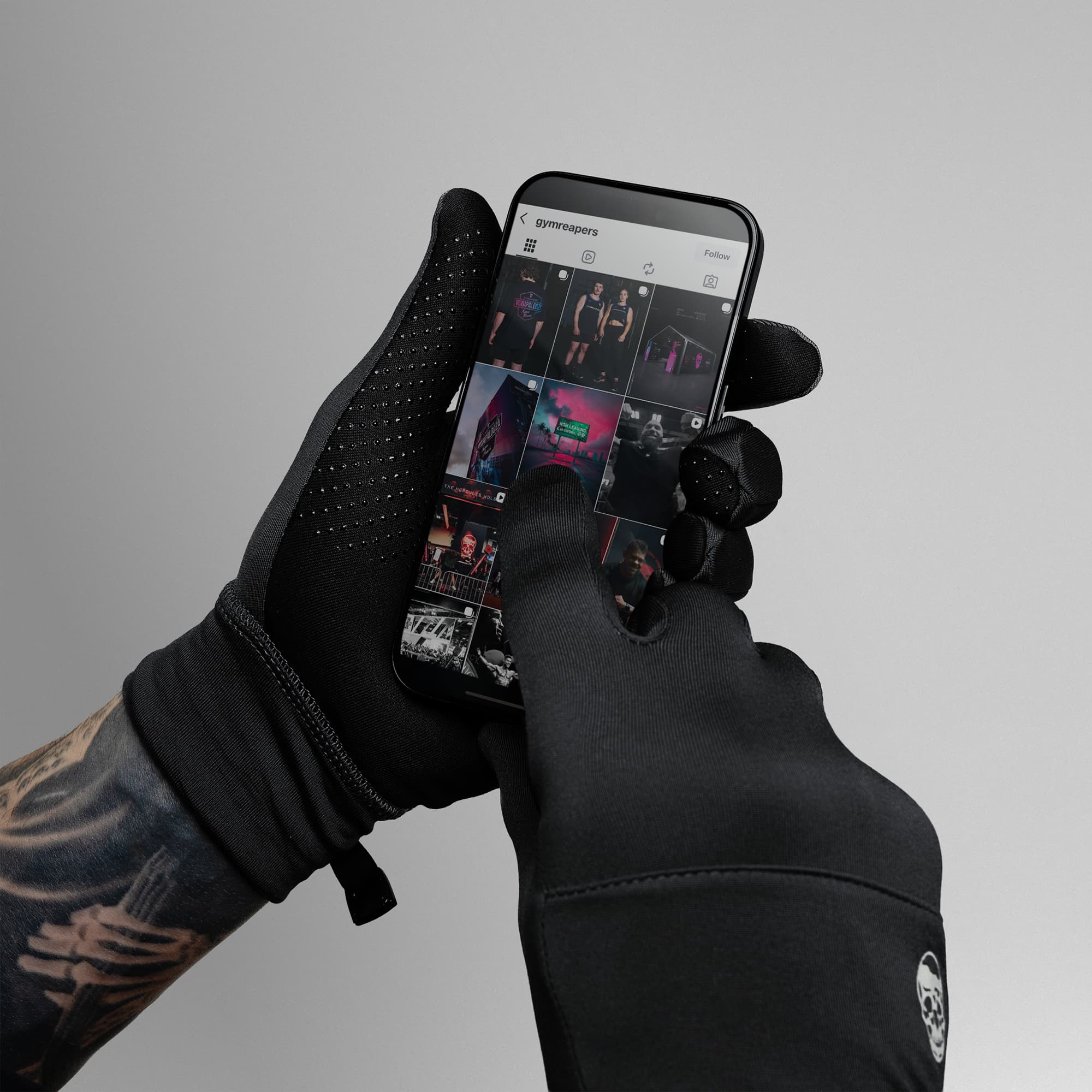 Model wearing Black Stryda™ Run Gloves using phone showcasing touchscreen compatibility