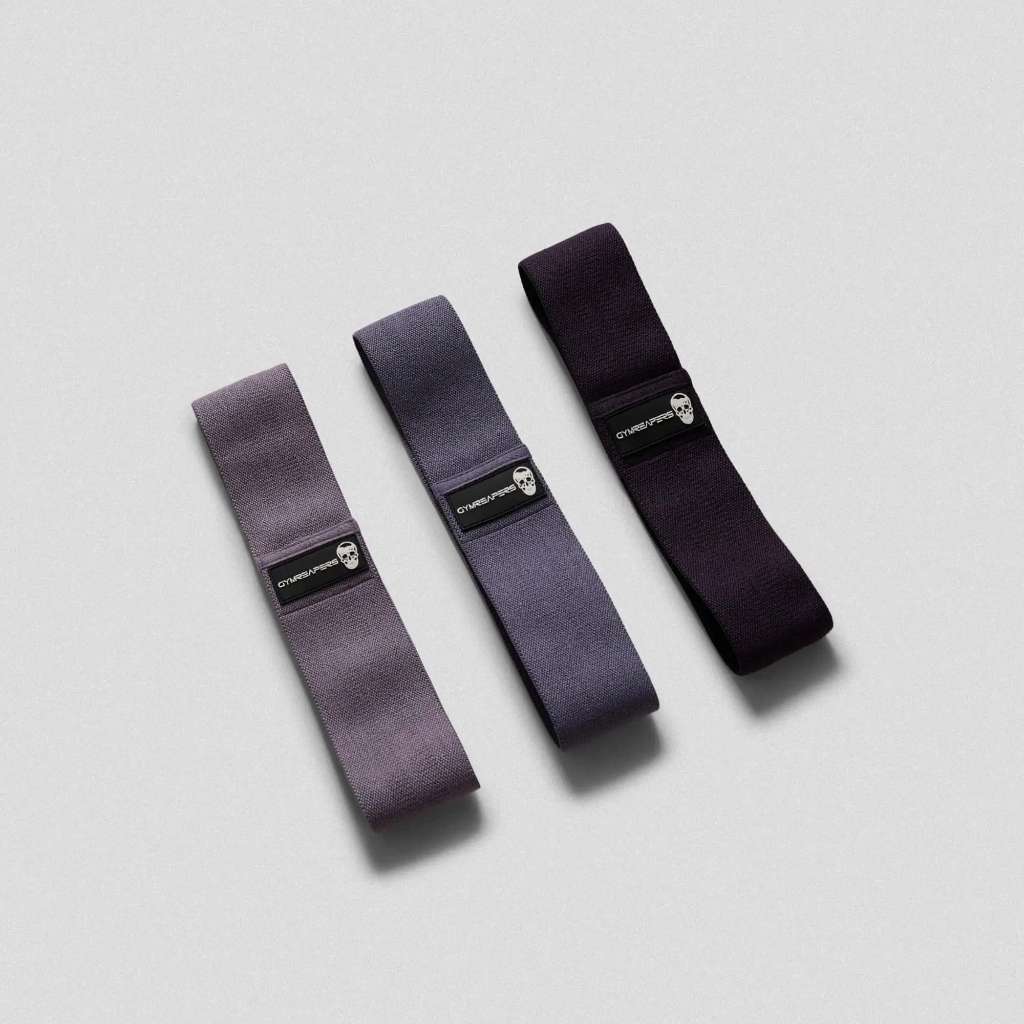 photo of purple hip bands side by side on gray background 