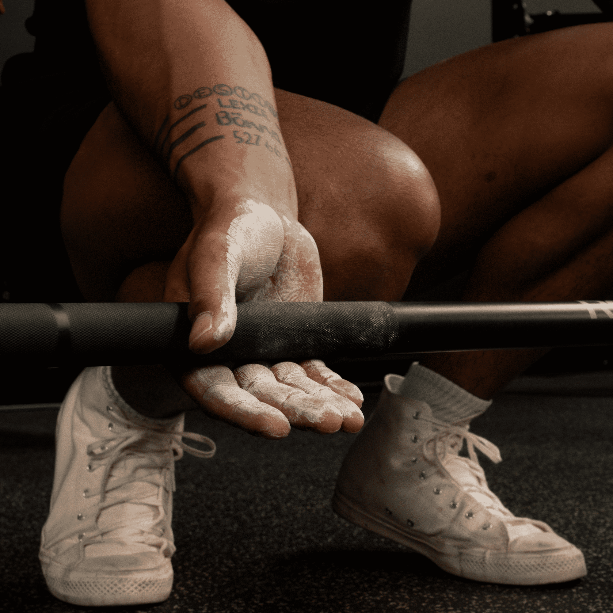 liquid chalk being used on barbell