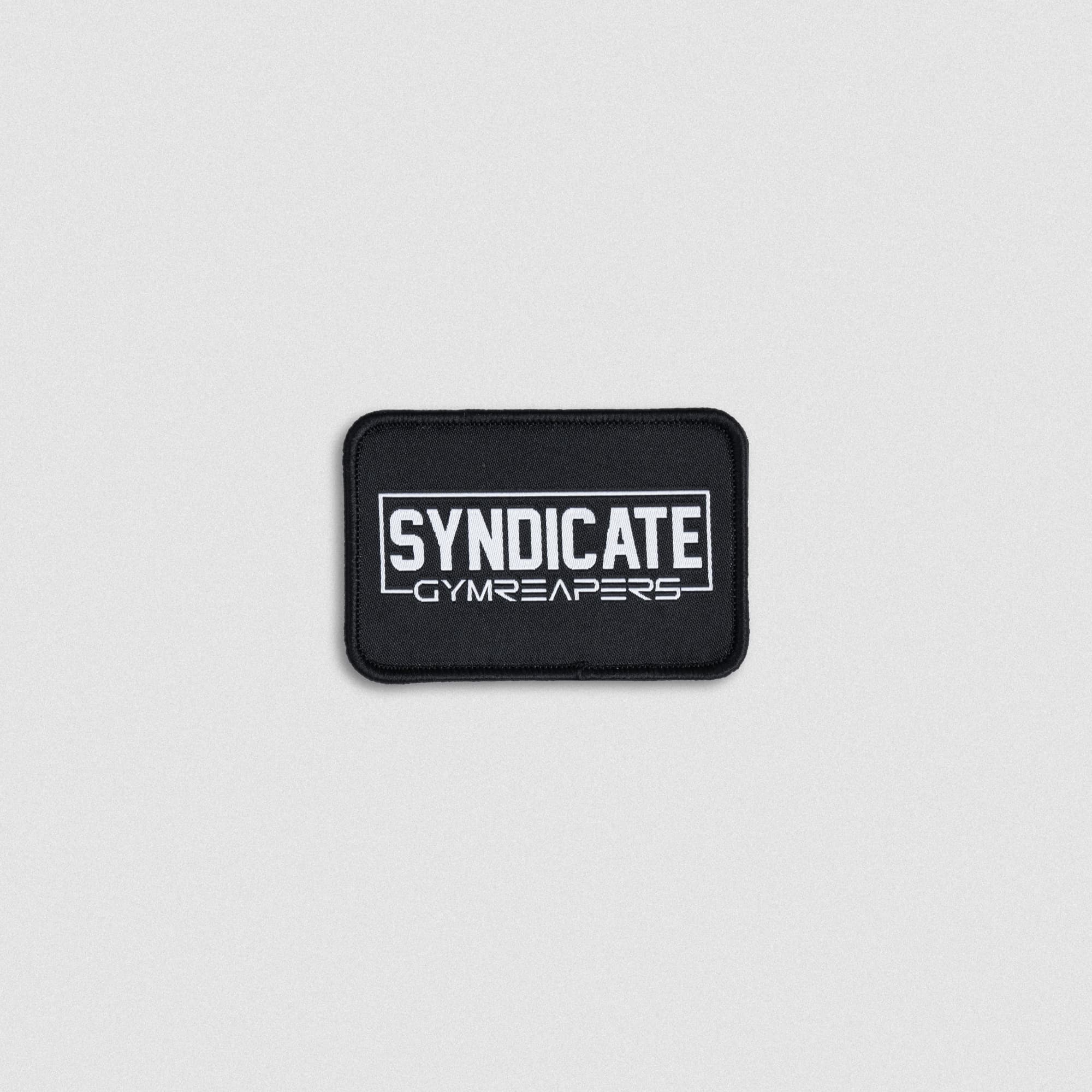 Black SYNDICATE x GYMREAPERS patch with white embroidered logo.