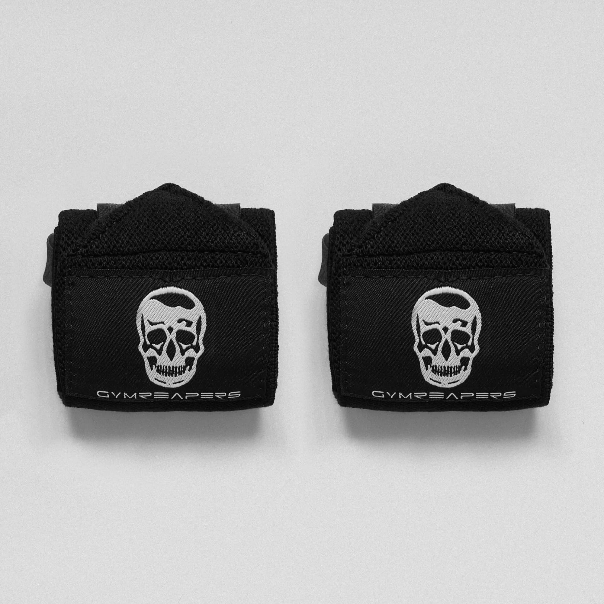 black wrist wraps on studio gray background.
